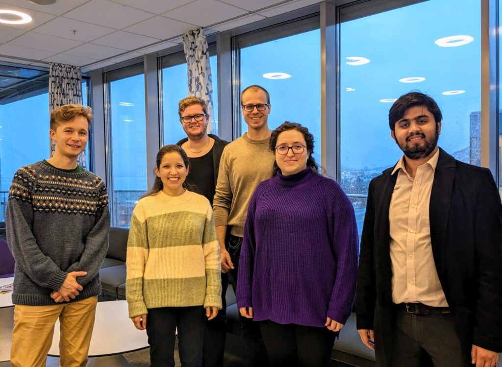 Photo of the Optica Ambassadors Richard and Alessandra with the leadership of Arctic Optica (Jehona, Jon-Richard, and Abhishek) and Roman.
