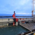 person, cleaning, deck, ship, red, blue, arctic, ocean, sky