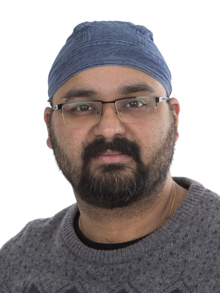 Indian man with glasses, beard, and mustache