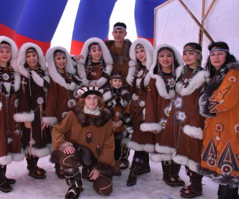 Group of dancers wearing traditional Russian Indigenous clothing.